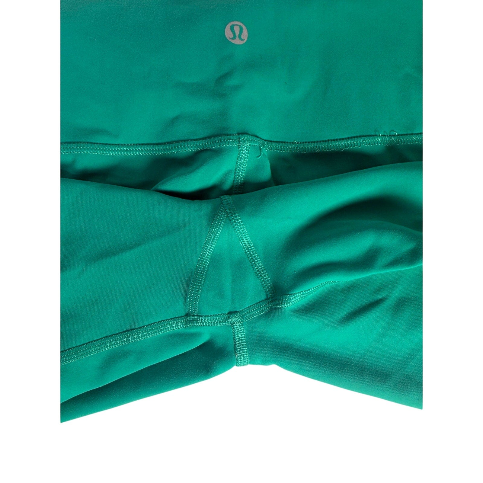 Lululemon women's teal green high-rise biker shorts size 6, form-fitting athletic shorts with a sleek waistband and smooth fabric.