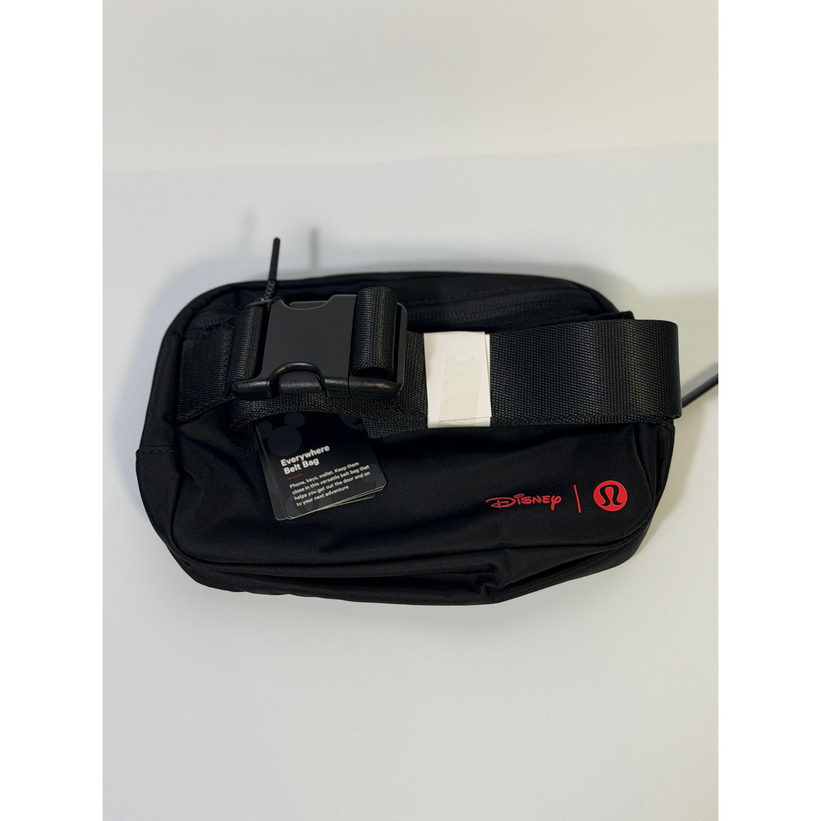 Lululemon Disney Mickey Mouse black embroidered belt bag featuring a compact design and adjustable strap.