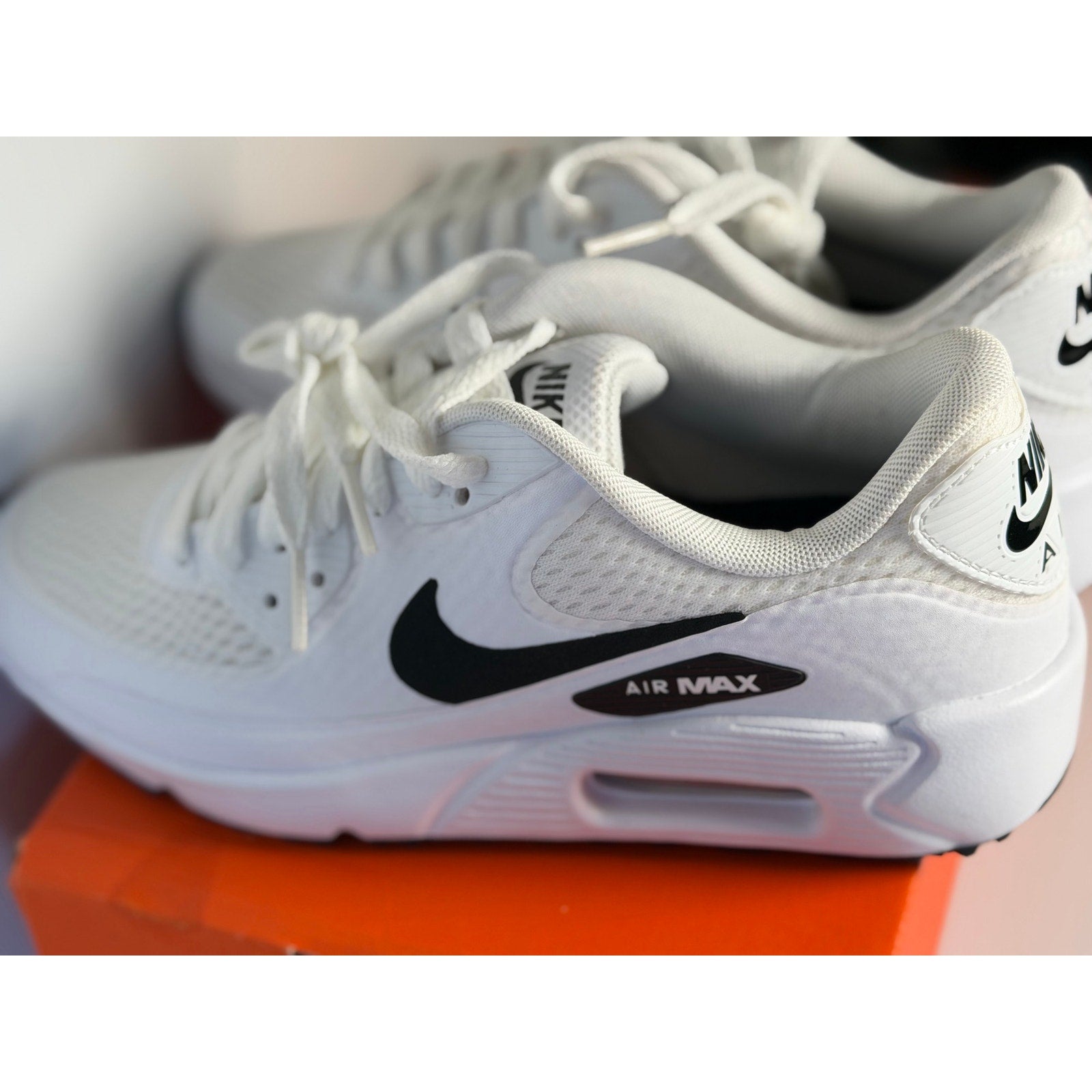 Nike Air Max 90 G golf shoes in white and black, designed for men and women, with sporty athletic style and durable traction soles.