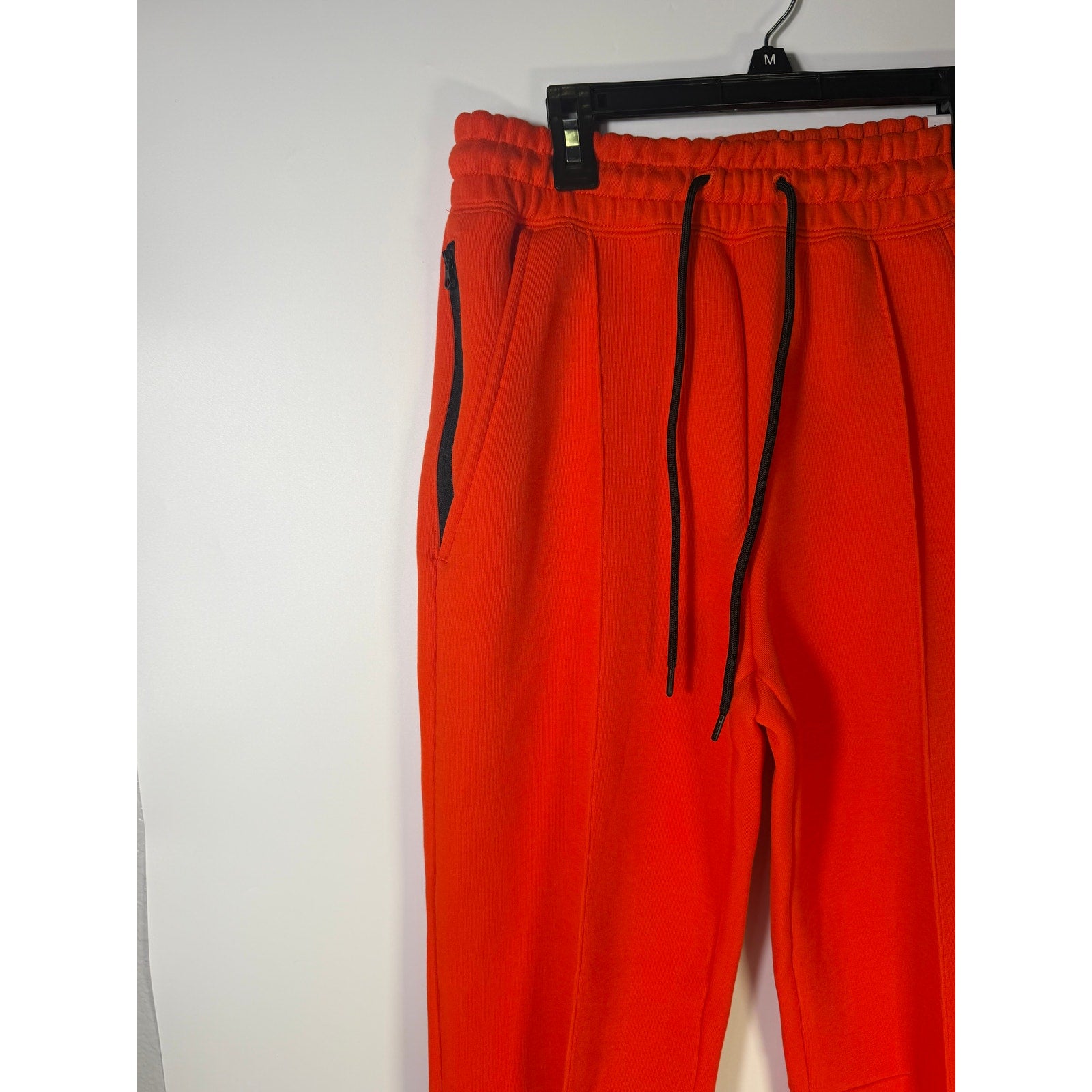 Nike Sportswear Phoenix Fleece Jogger Pants for women in bright orange, mid-rise with a relaxed fit and fleece material.