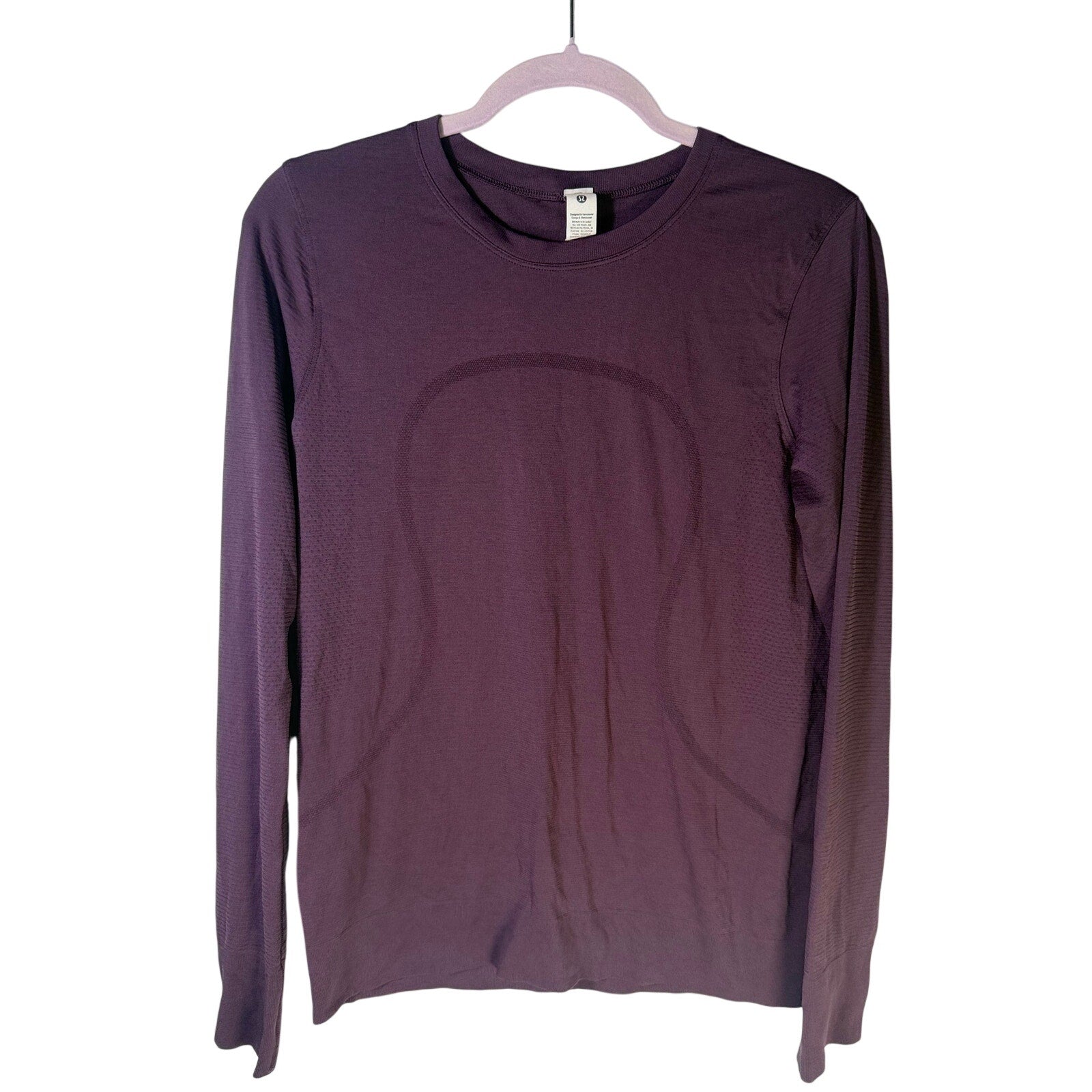 Lululemon women’s Swiftly Tech long-sleeve athletic shirt in purple, size 6, with fitted design and moisture-wicking fabric.