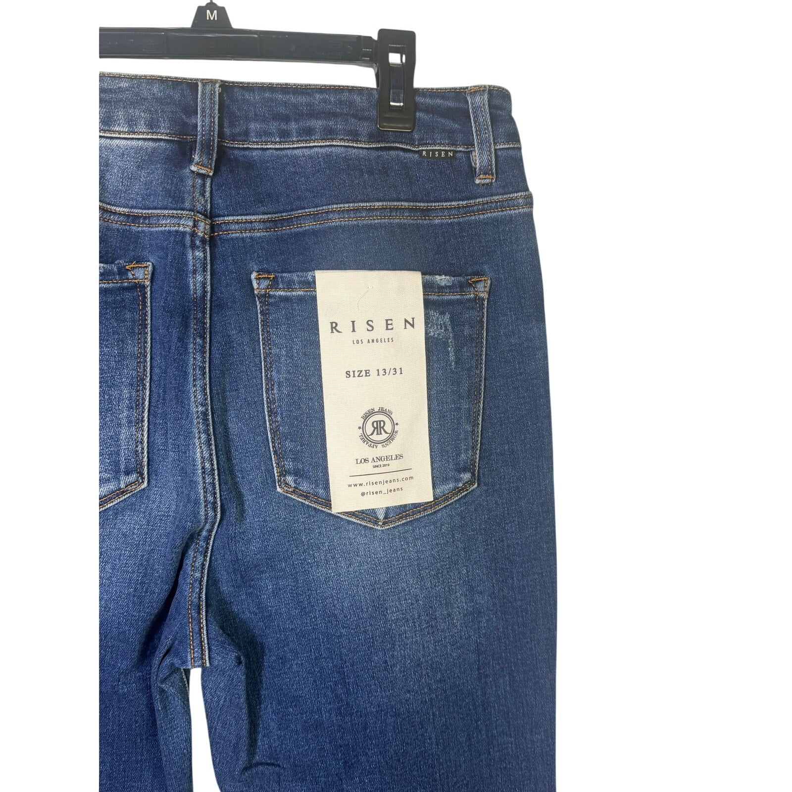 Risen Jeans women's size 13/31 dark wash distressed flare jeans, showing fitted waist, flared legs, and distressed details.