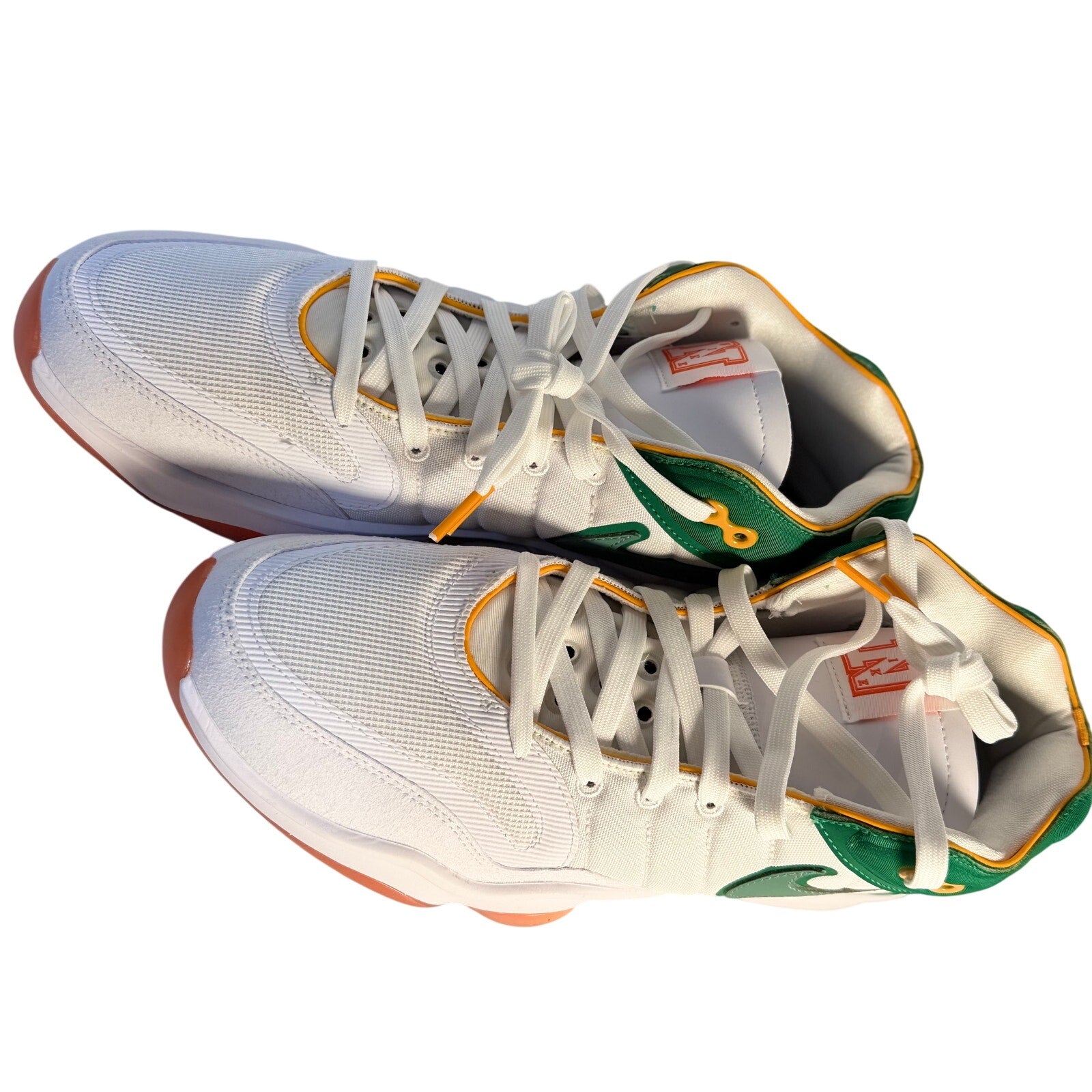 Nike men's athletic sneakers in white with green and orange accents, size 10.5, casual Nike sneakers with laces and sporty design.