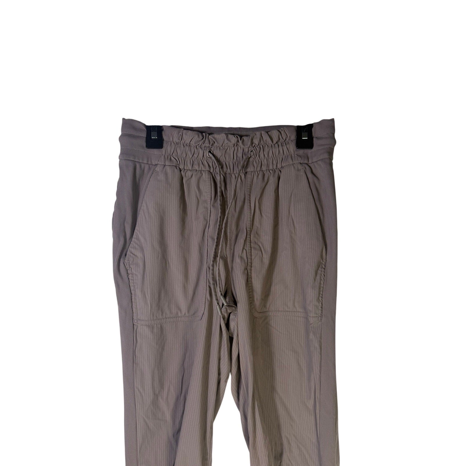 Lululemon women's taupe gray high-rise ruched tapered pants, size 4, preowned, with a fitted waist and tapered leg design.