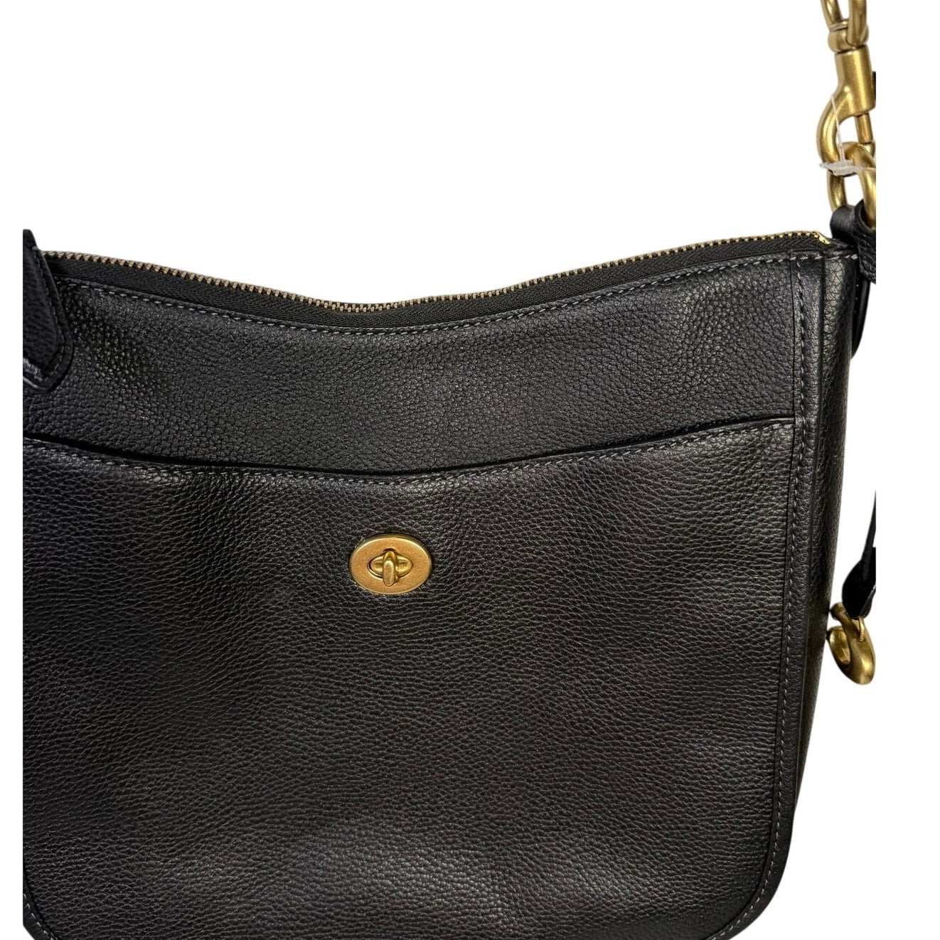 Coach black pebbled leather crossbody handbag with gold-tone hardware, featuring a compact, stylish shoulder bag design.