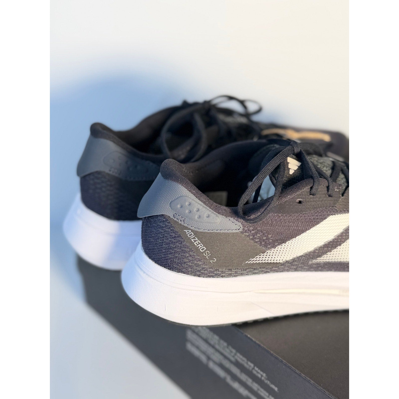 Men's Adidas Adizero SL2 running shoes in black and white with Lightstrike cushioning, size 6.5, athletic footwear for running.