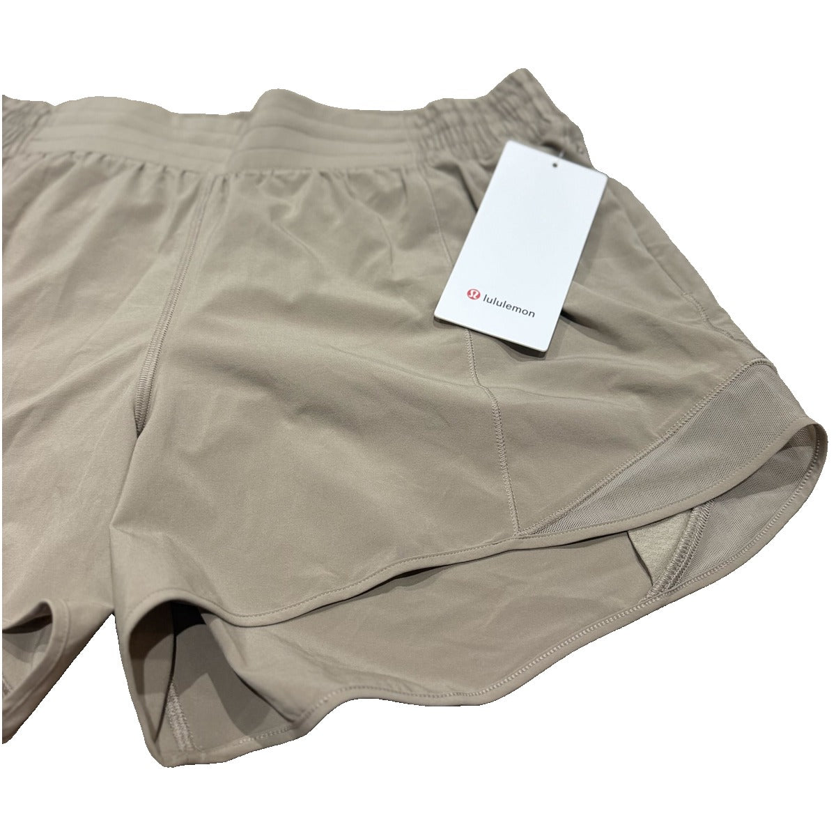 Lululemon Hotty Hot high-rise lined running shorts in tan beige, women's size 14, showing the lightweight fabric and comfortable fit.