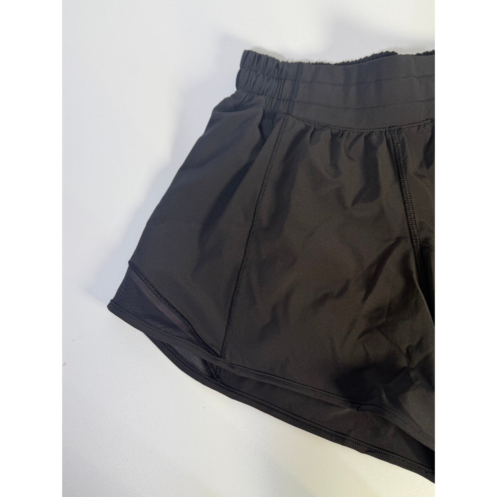 Black Lululemon Hotty Hot Low Rise Lined Shorts for women, size 4, showing the front view with waistband and lining detail.