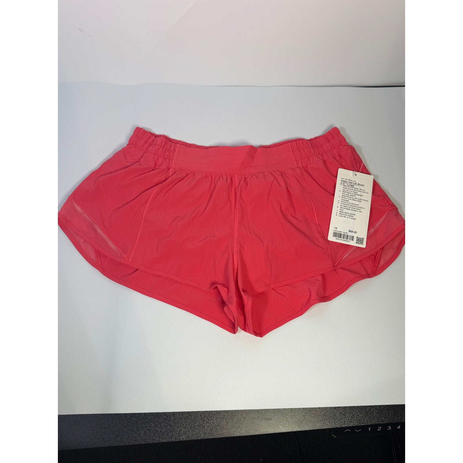 Lululemon Hotty Hot lined shorts in glaze pink, low rise, 2.5-inch length, women's size 14, visible waistband and lining.