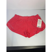 Lululemon Hotty Hot lined shorts in glaze pink, low rise, 2.5-inch length, women's size 14, visible waistband and lining.