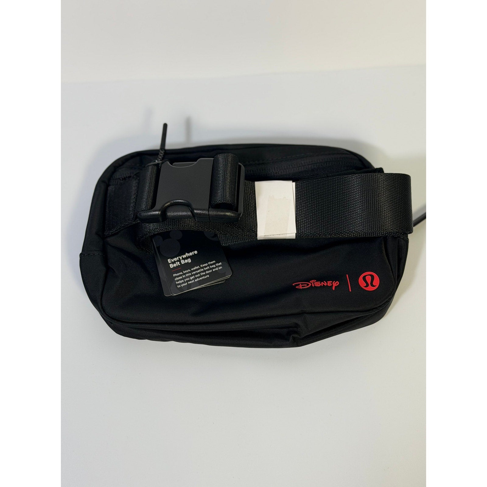 Lululemon Disney Mickey Mouse black embroidered belt bag with adjustable strap and zipper closure, stylish and compact accessory.