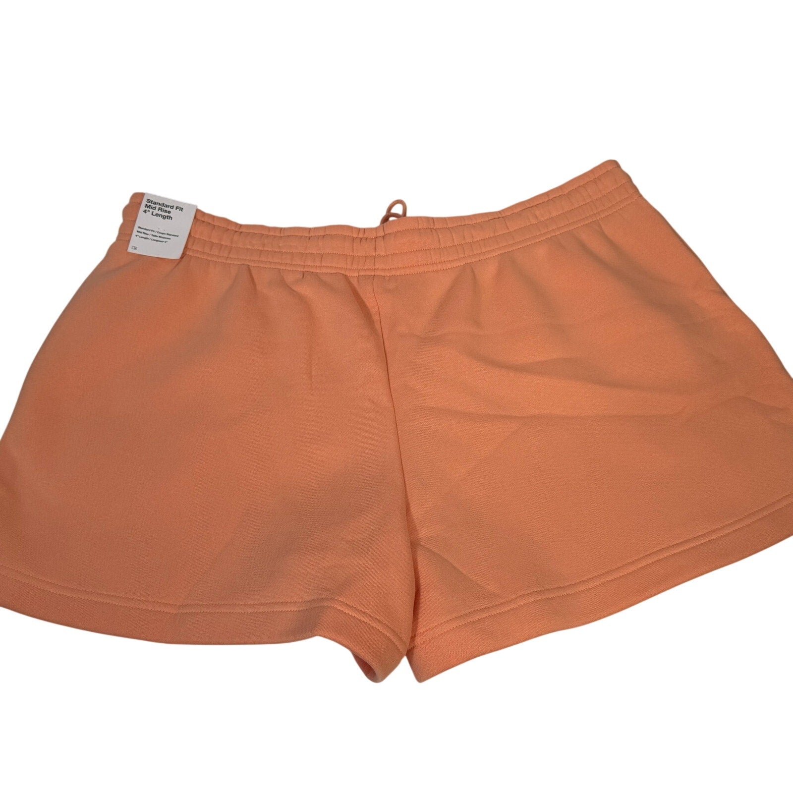 Nike women’s peach orange fleece drawstring shorts in size XL, featuring a comfortable, casual fit with an elastic waistband.