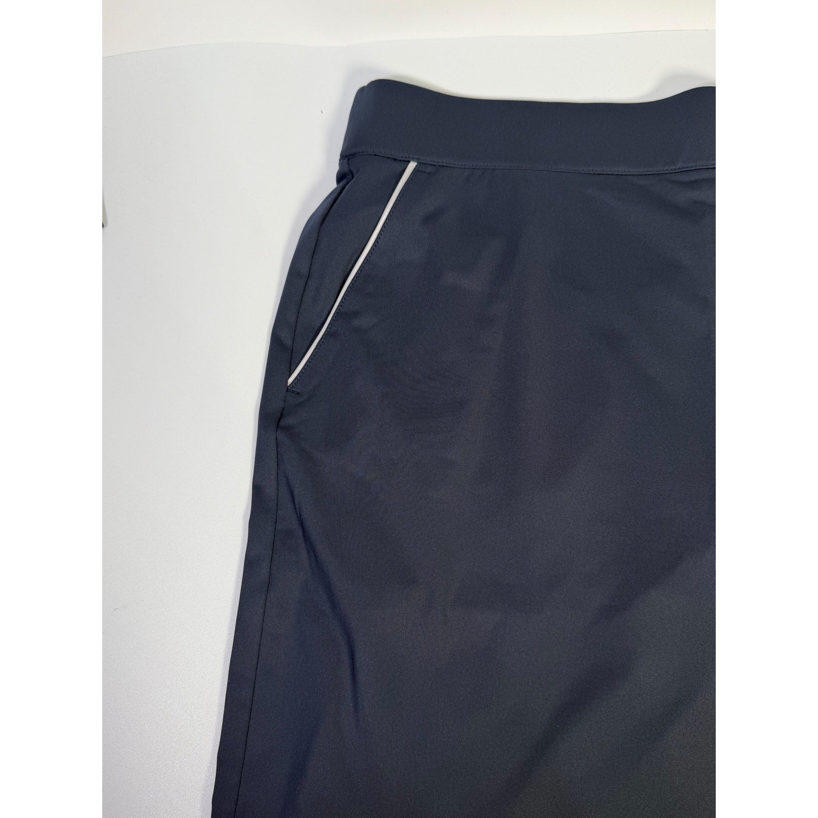 Dunning women's navy golf skort with built-in shorts, athletic style, size large, featuring a skirt and shorts combination.