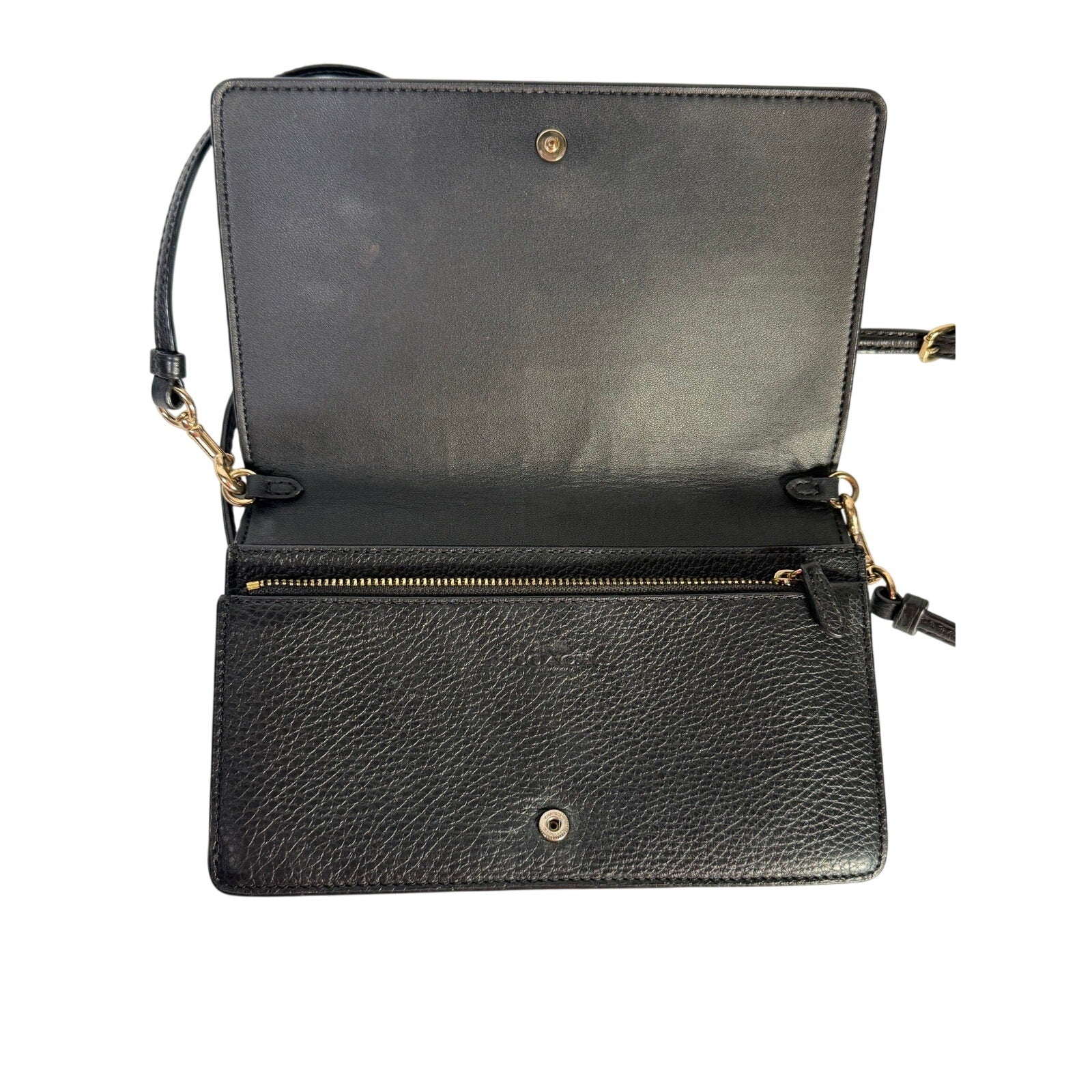 Coach women's black leather foldover crossbody wallet bag with adjustable strap, featuring sleek design and compact handbag style.
