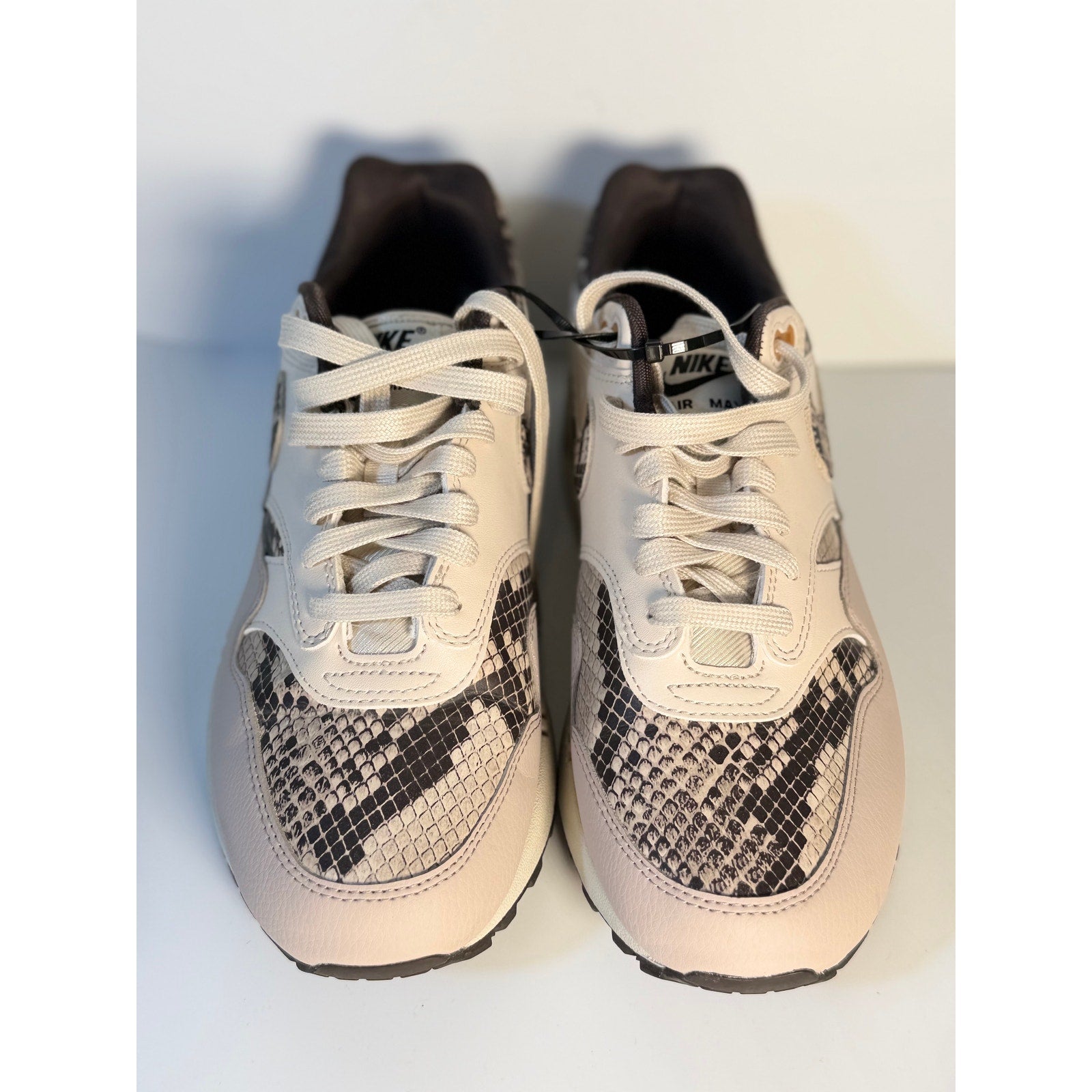 Nike Air Max 1 Premium snakeskin sneakers in white and gray, women's US 9.5, featuring textured snakeskin pattern and sporty design.