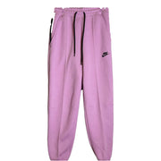 Women's Nike Sportswear Tech Fleece joggers in pink, mid-rise, size XS, showcasing soft fleece fabric and relaxed fit.