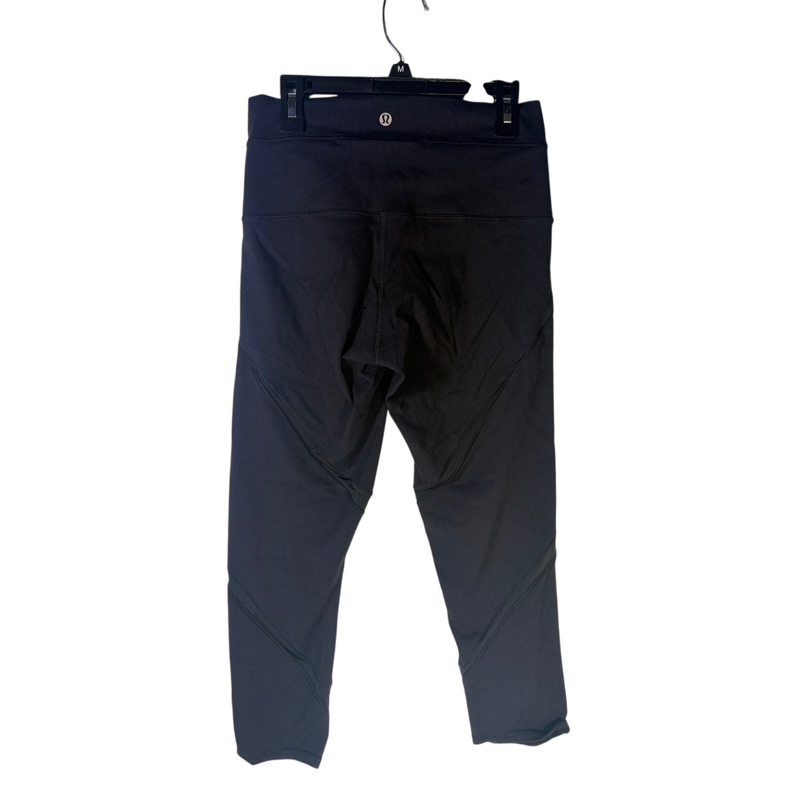 Lululemon women's high-rise paneled cropped leggings in black, size 6, showing the fitted waistband and sleek design.