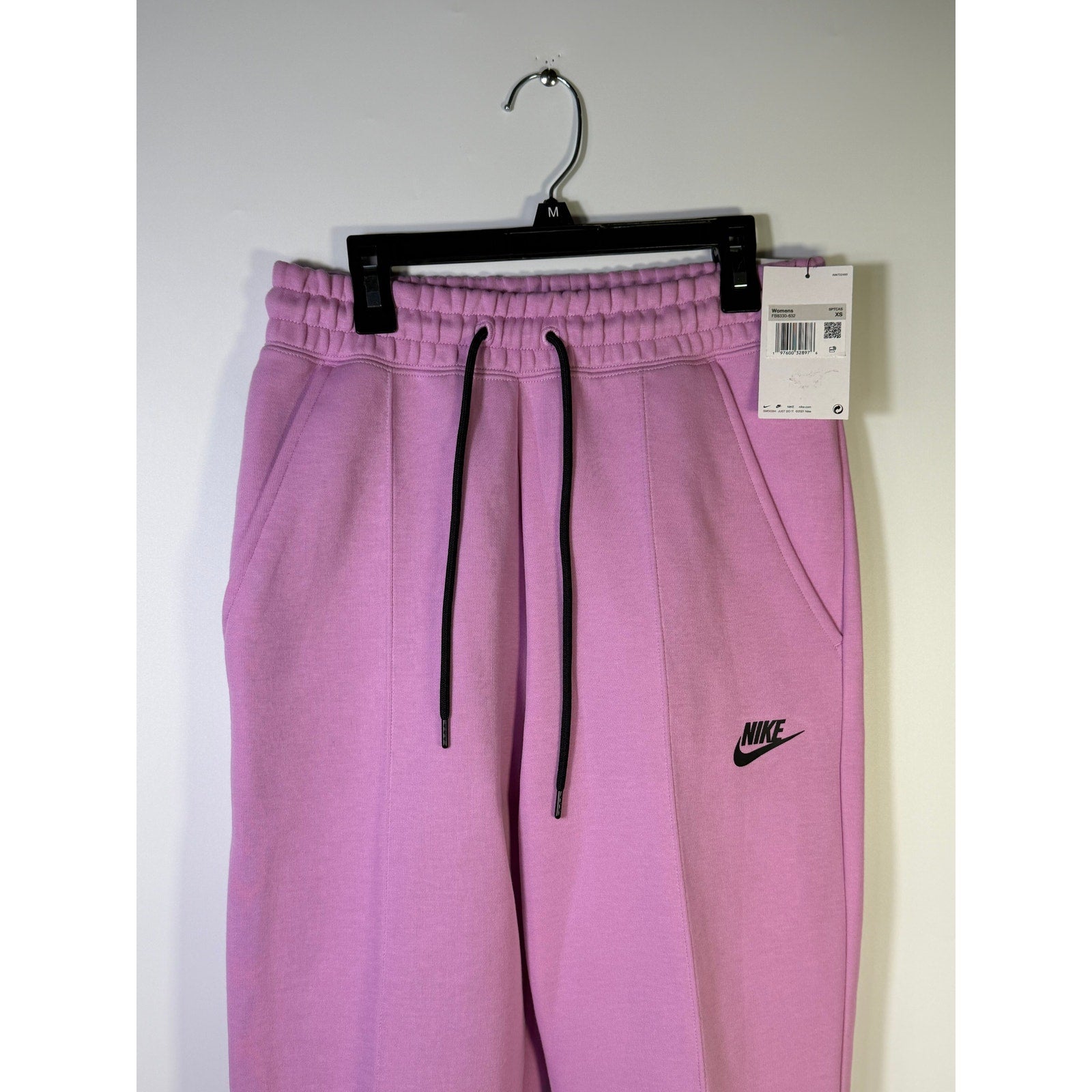 Pink Nike Sportswear Phoenix fleece jogger sweatpants for women, mid-rise fit, size XS, soft fleece material.