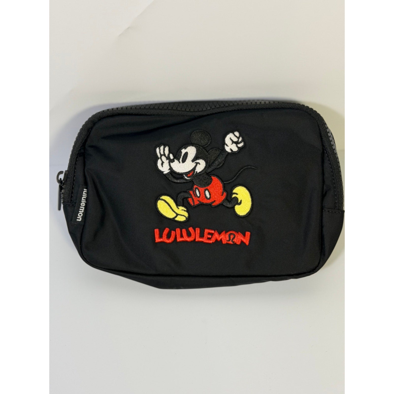 Lululemon Disney Mickey Mouse embroidered black belt bag, stylish and compact accessory with adjustable strap and playful design.