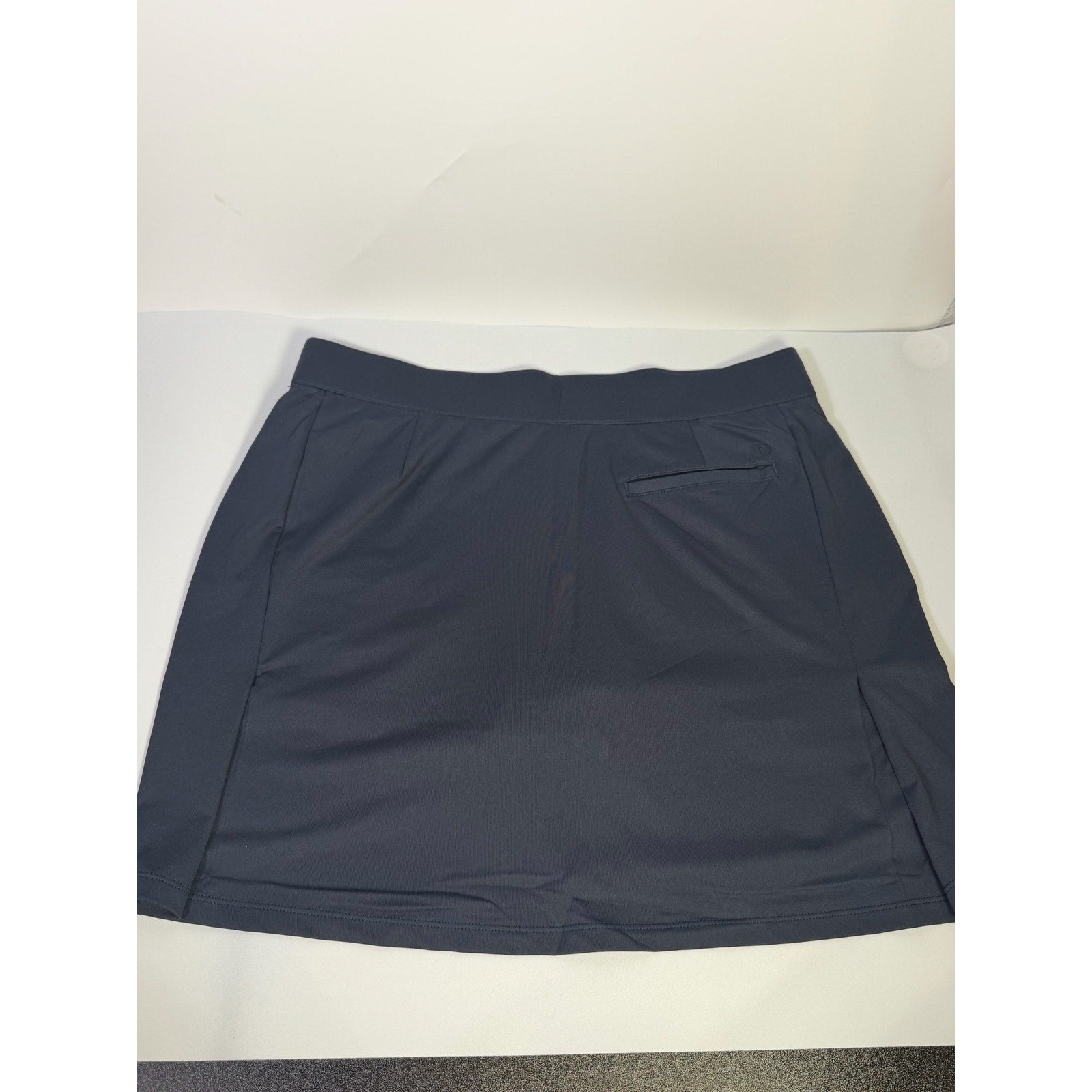 Dunning women's navy golf skort with built-in shorts, athletic design, front pleats, size large, suitable for sports and casual wear.