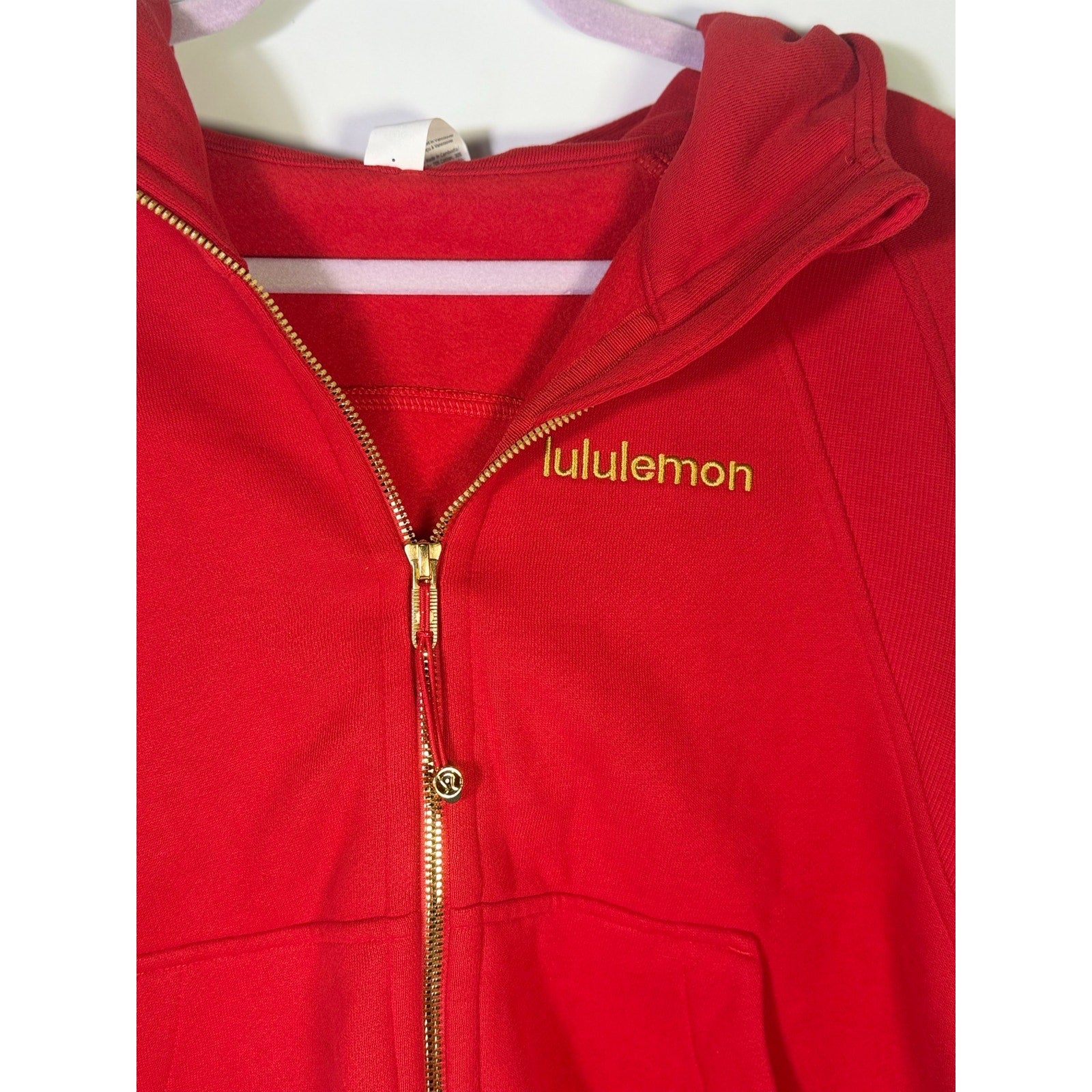 Lululemon women’s red scuba oversized full-zip hoodie, size M/L, showing front view with gold accents and relaxed fit.