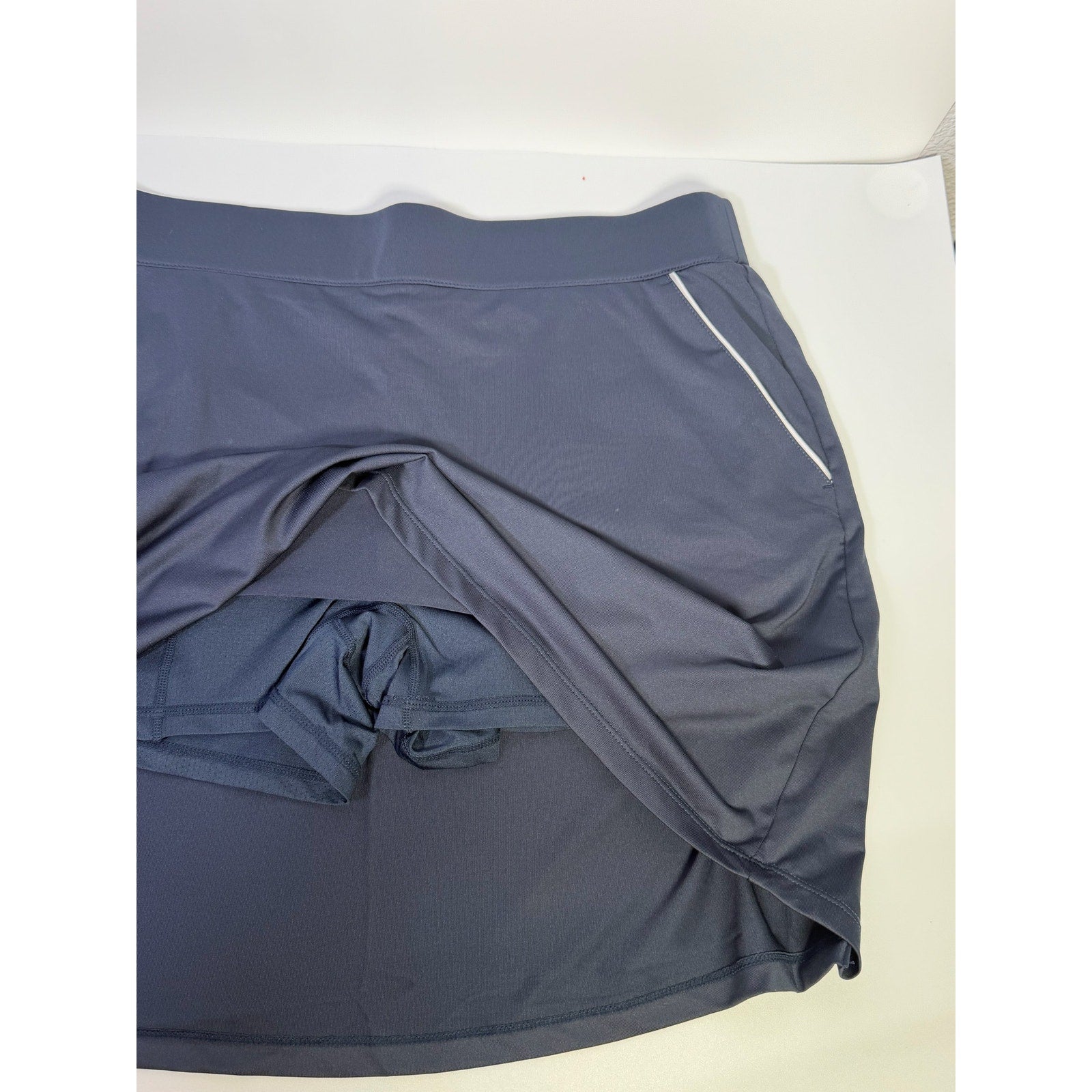 Dunning women's navy golf skort with built-in shorts, athletic skirt style, size large, featuring a comfortable waistband and athletic fabric.