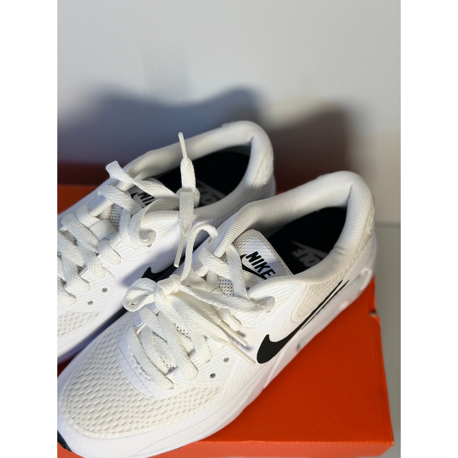 Nike Air Max 90 G golf shoes for women in white and black, featuring cushioned soles and sporty design.