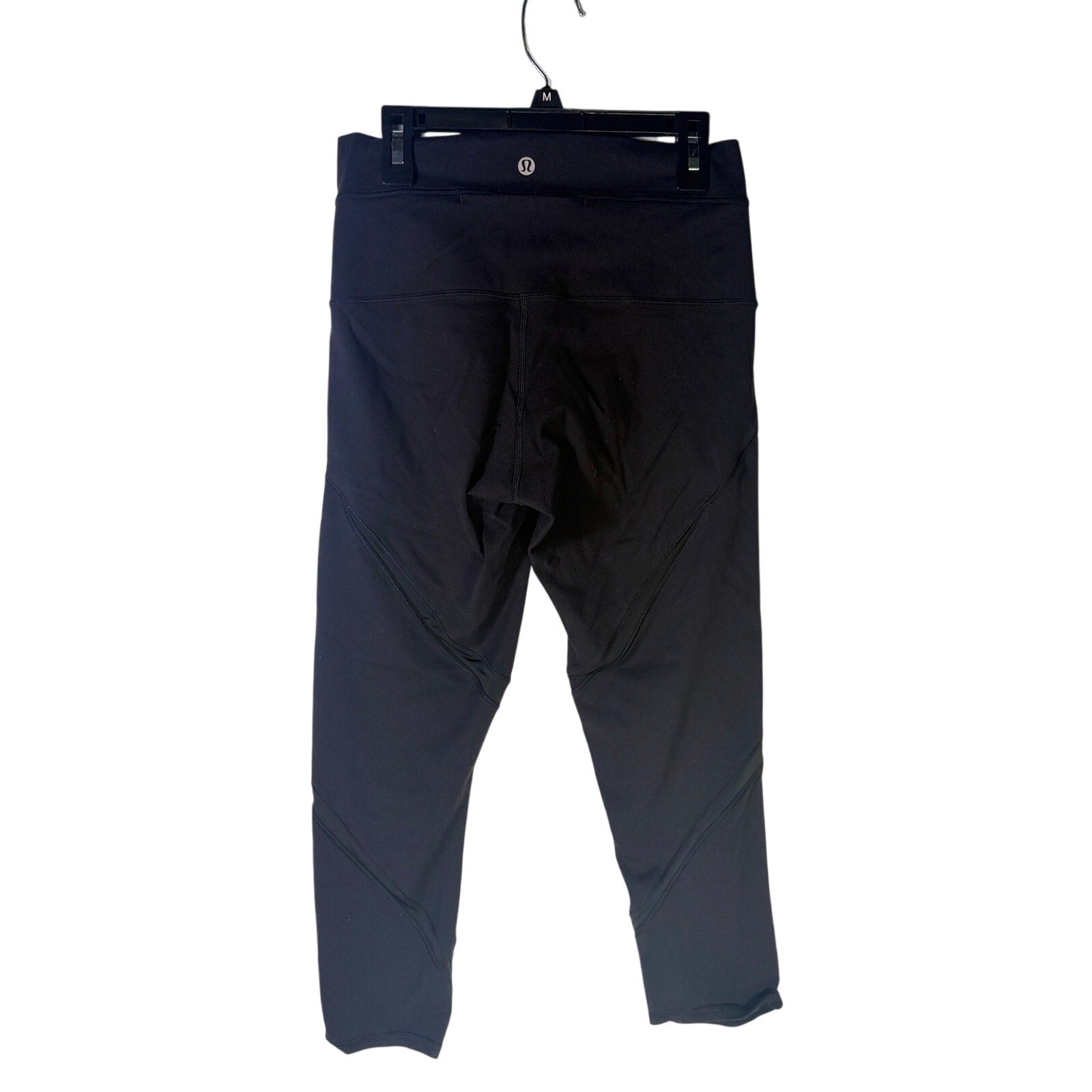Lululemon women's high-rise paneled cropped leggings in black, size 6, with a close-up of the stretchy fabric and panel details.