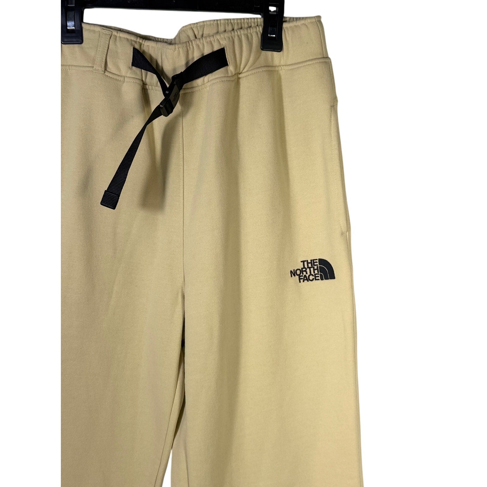 The North Face men's AXYS sweatpants in gravel beige, size small, showing the relaxed fit and logo detail.