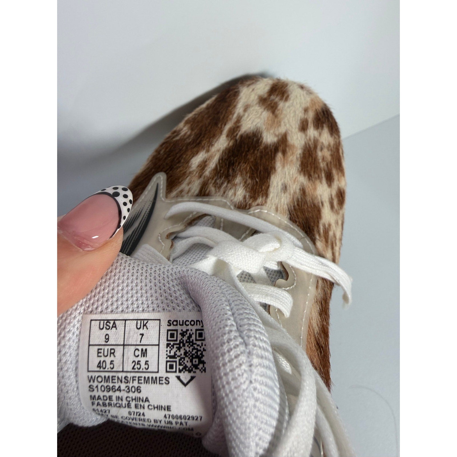 Saucony women's Endorphin Shift 3 Runshield cow print athletic running shoes, size 9, with black and white cow pattern.