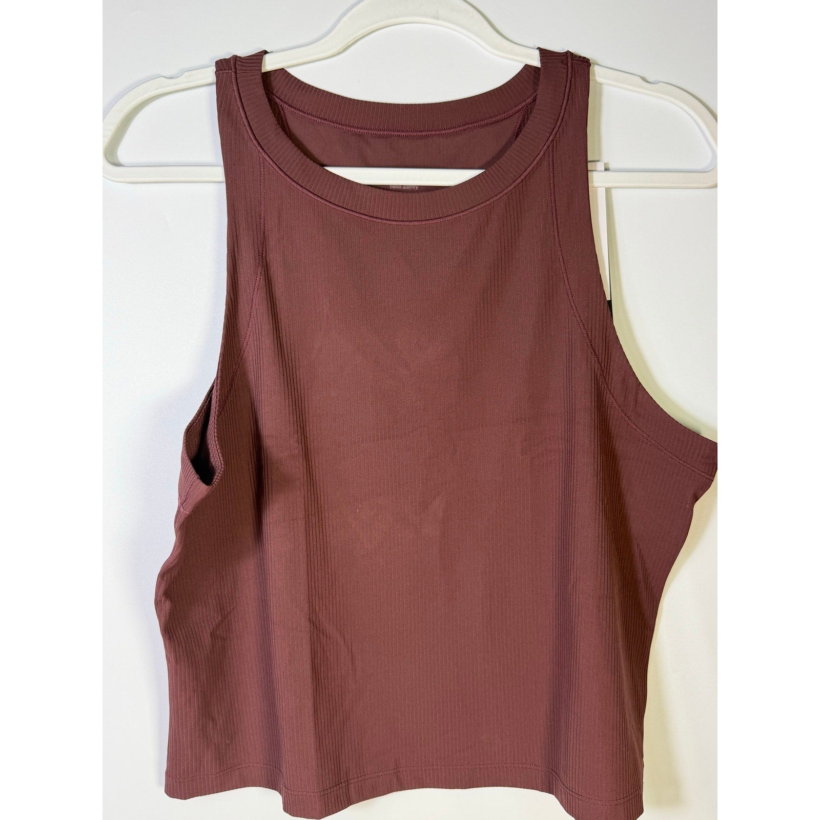 Nike women’s ribbed cropped muscle tank top in brown, size L, featuring a fitted sleeveless design perfect for athletic wear.