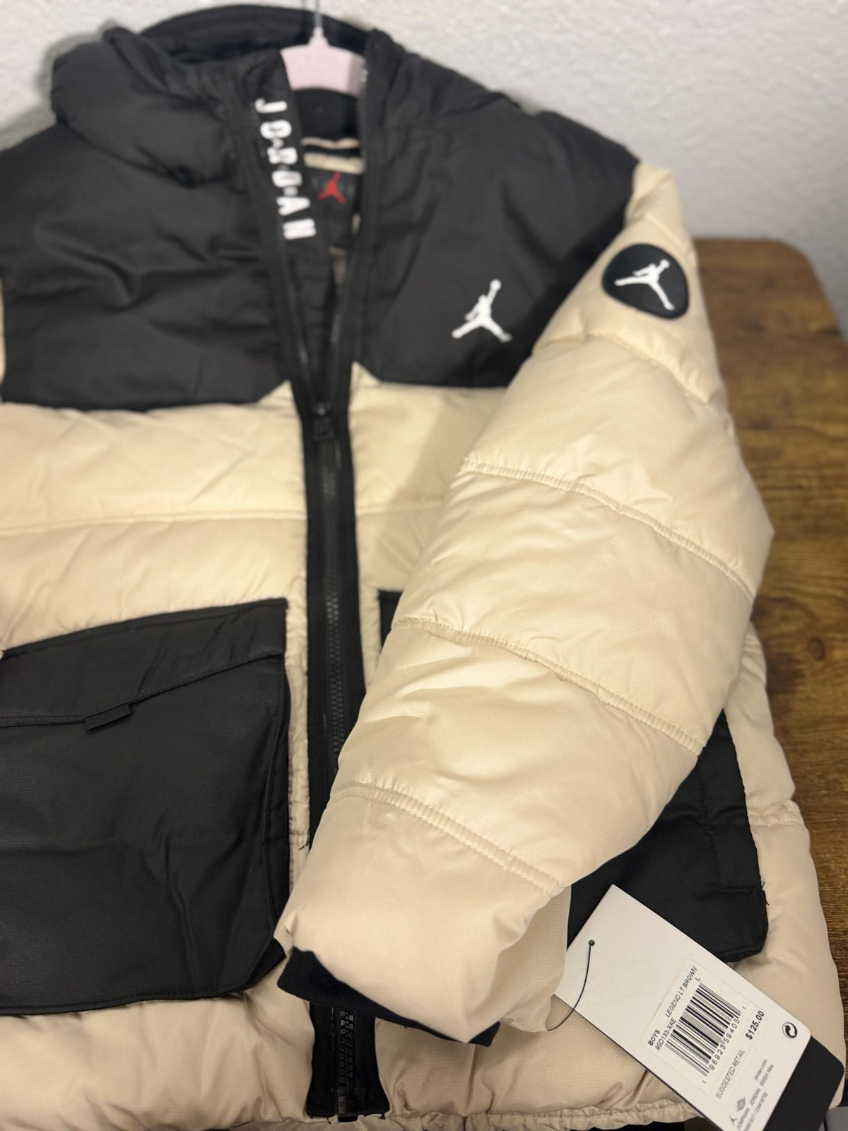 Jordan Jumpman hooded puffer jacket for boys in legend light brown and black, featuring a padded design and hood.