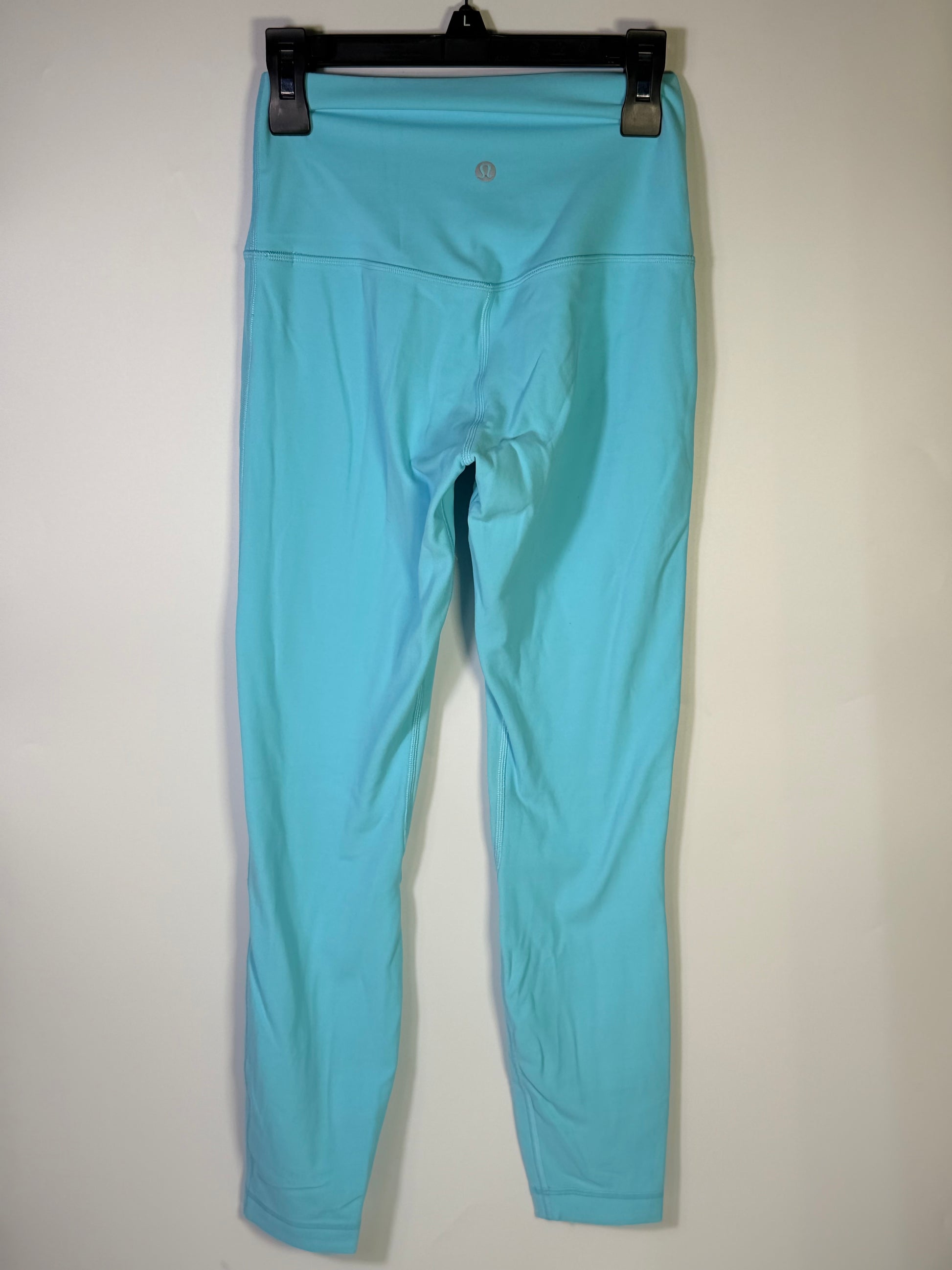 Lululemon women's size 4 aqua blue high-rise full-length leggings, close-up showing smooth fabric and comfortable fit.