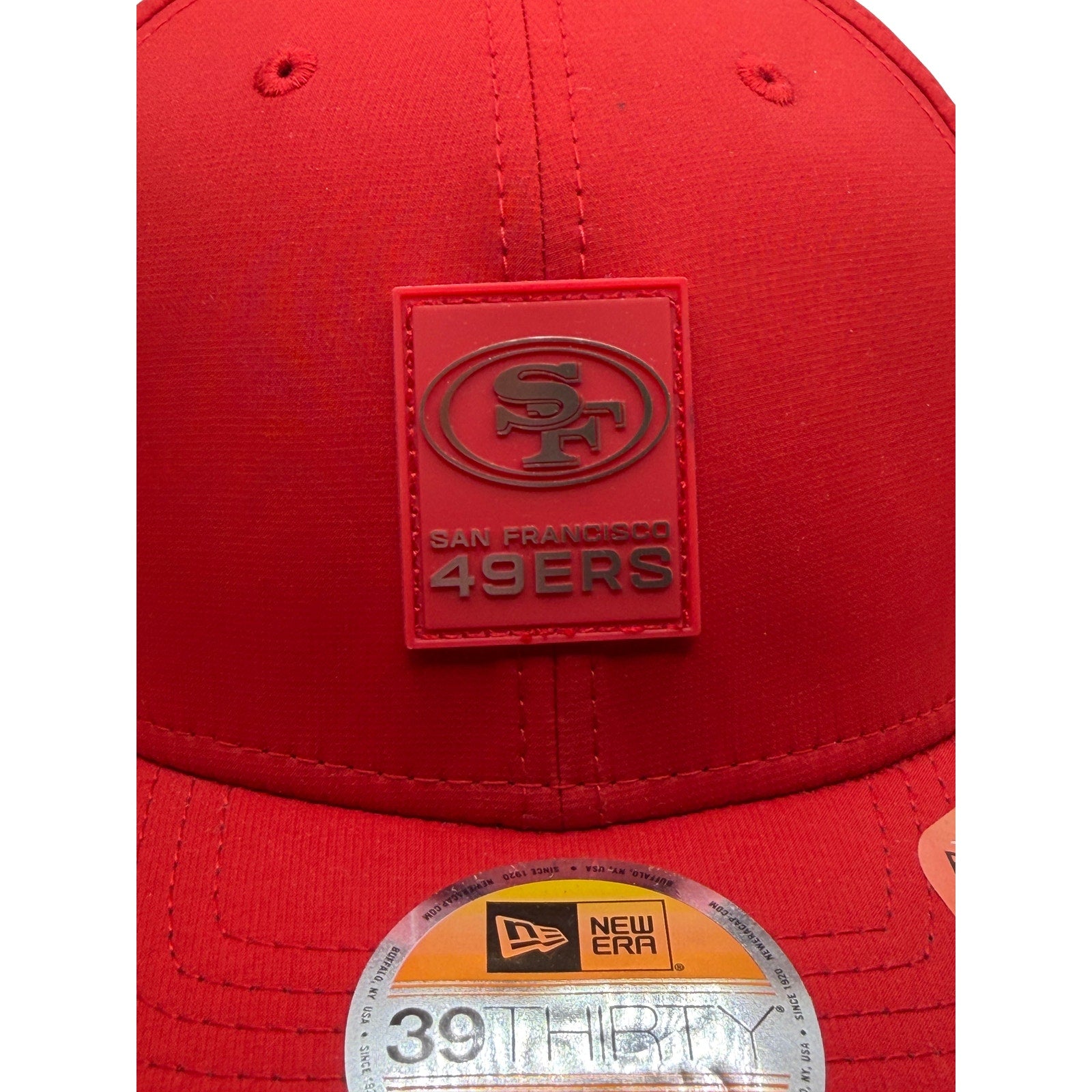 Red New Era NFL 49ers stretch fit hat in size L/XL, featuring team logo and curved brim, new with tags.