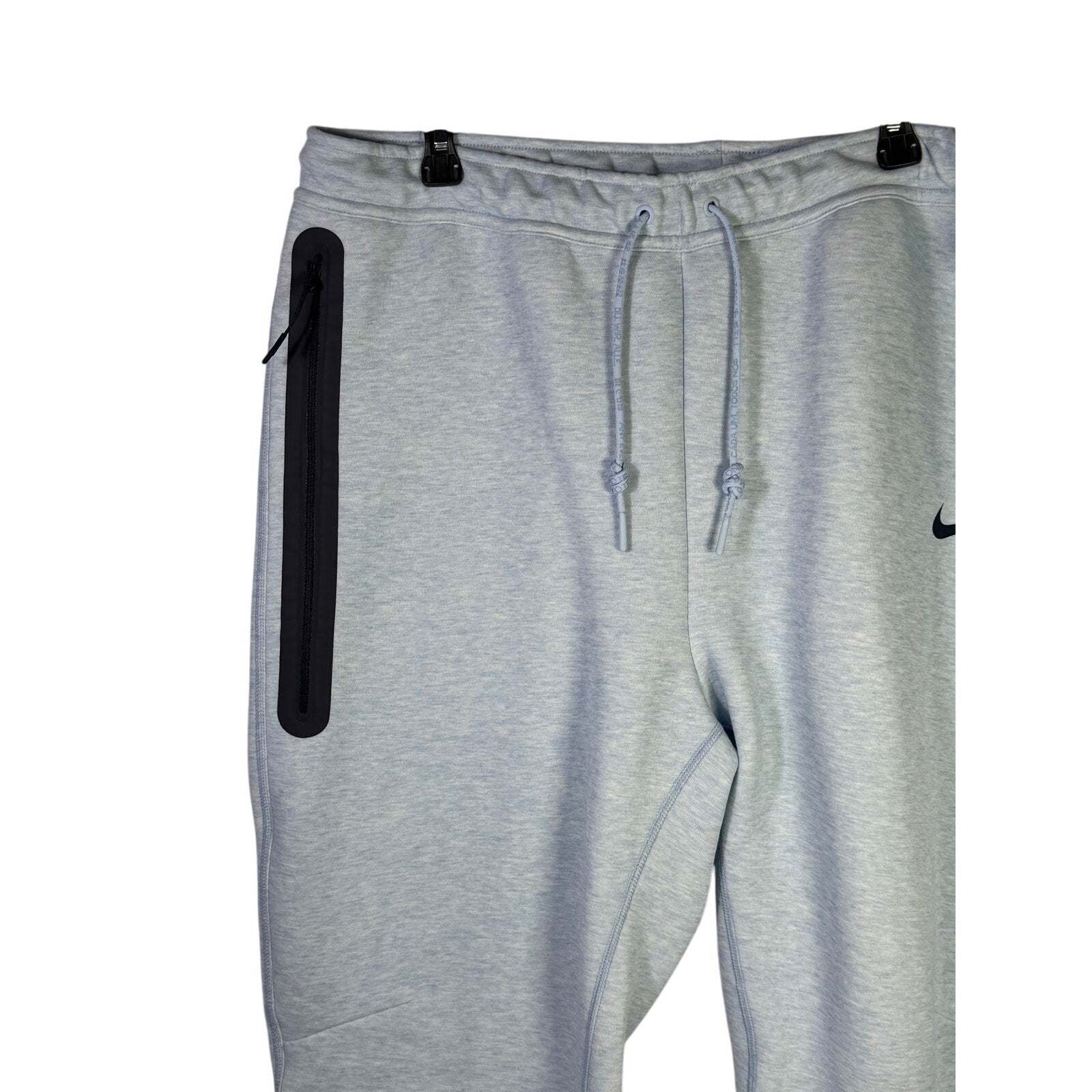 Nike Sportswear Tech Fleece Jogger Pants for men in light blue heather, showing the relaxed fit and elastic waistband.