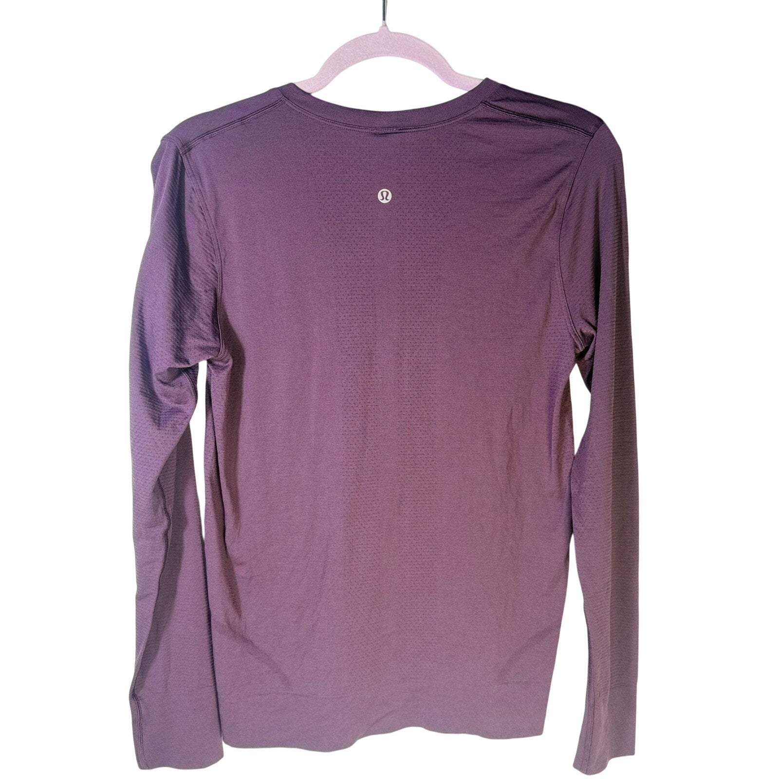 Lululemon women’s purple Swiftly Tech long-sleeve athletic shirt, size 6, with fitted design and breathable fabric.