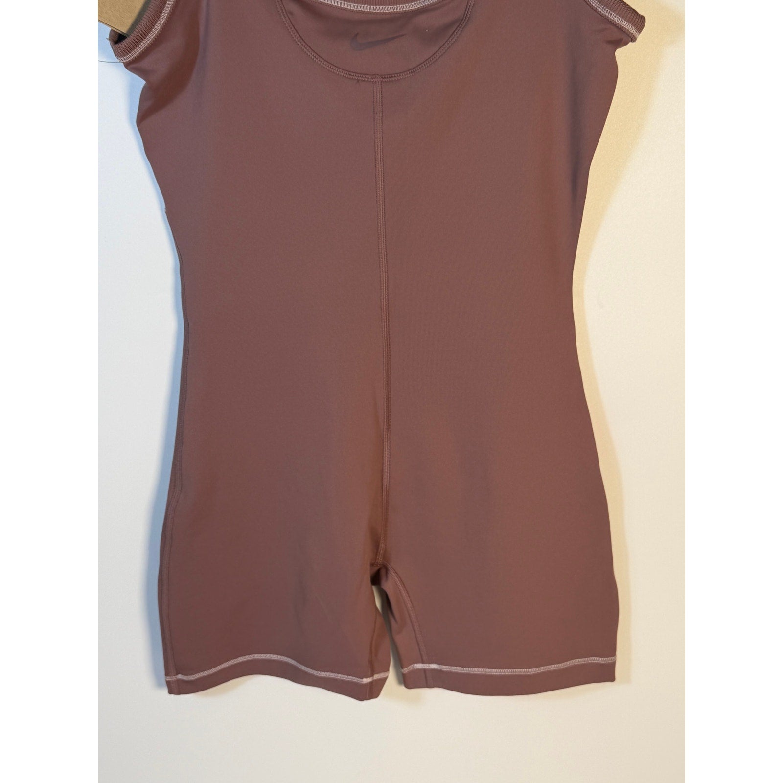 Nike women's mauve training romper, size small, one-piece bodysuit with athletic fit and zip front, new with tags.