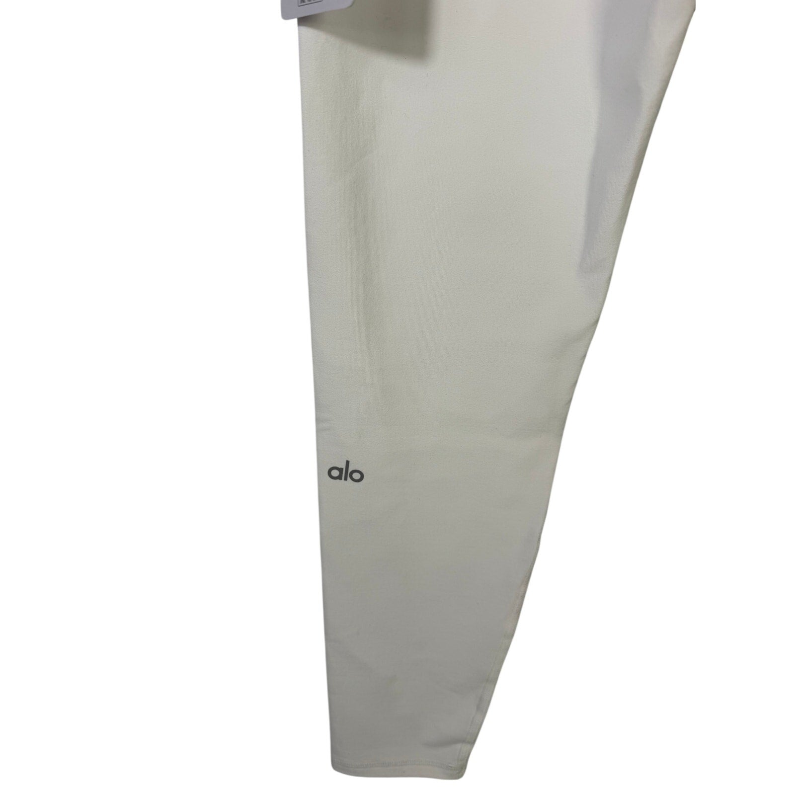 Alo Yoga 7/8 high waist airbrush leggings in white, women's large size, shown on a model highlighting the fitted yoga pants style.