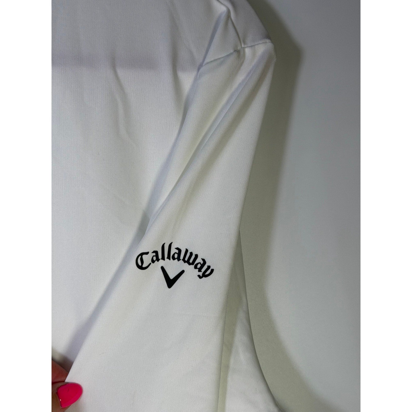 Callaway women's white Opti-Dri quarter zip golf sweatshirt, size large, displayed on a hanger.