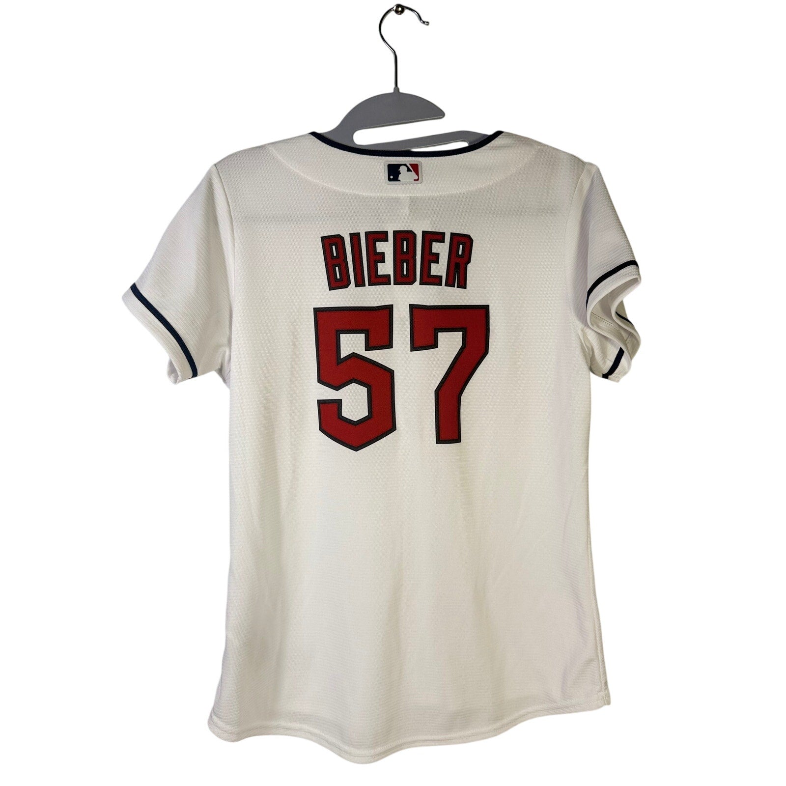 Nike Cleveland Guardians Shane Bieber #57 women's jersey in white, featuring team logo and player number on the front.