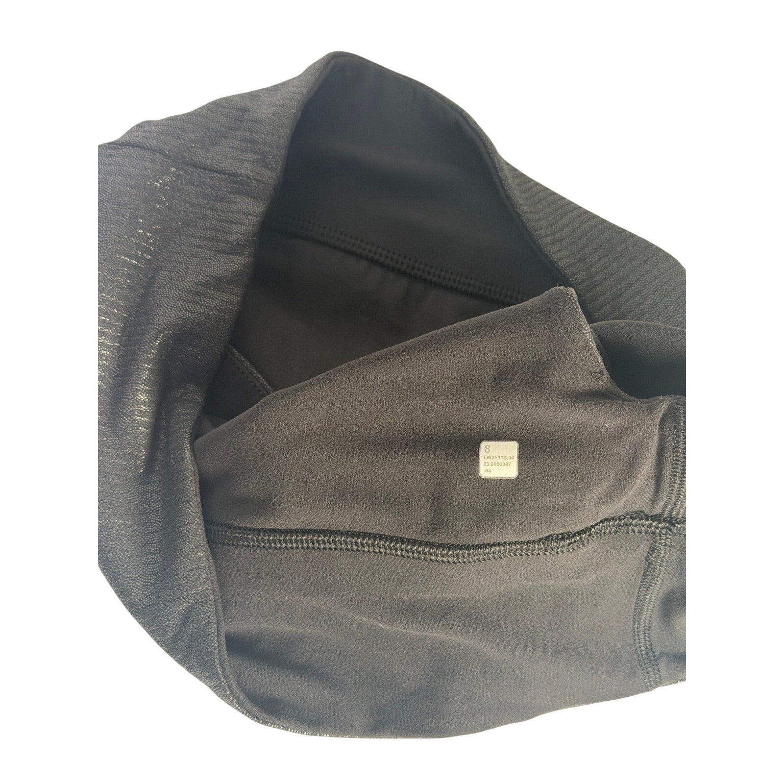 Lululemon women's black one-shoulder foil sports bra, size 8, featuring sleek design and supportive fit.