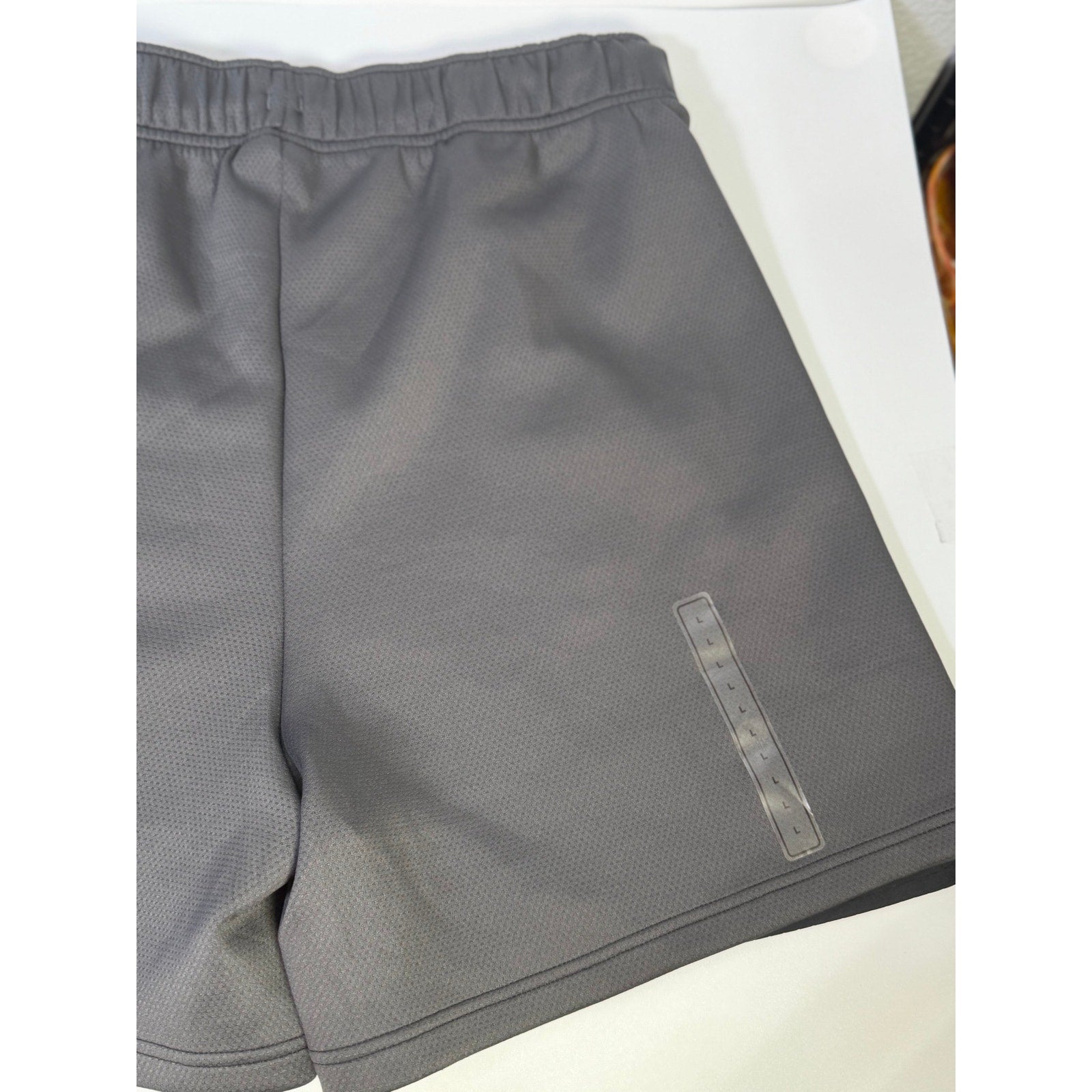 Black Nike ACG Death Bloom women’s cargo shorts, size M, displayed flat with pockets and adjustable waist details.