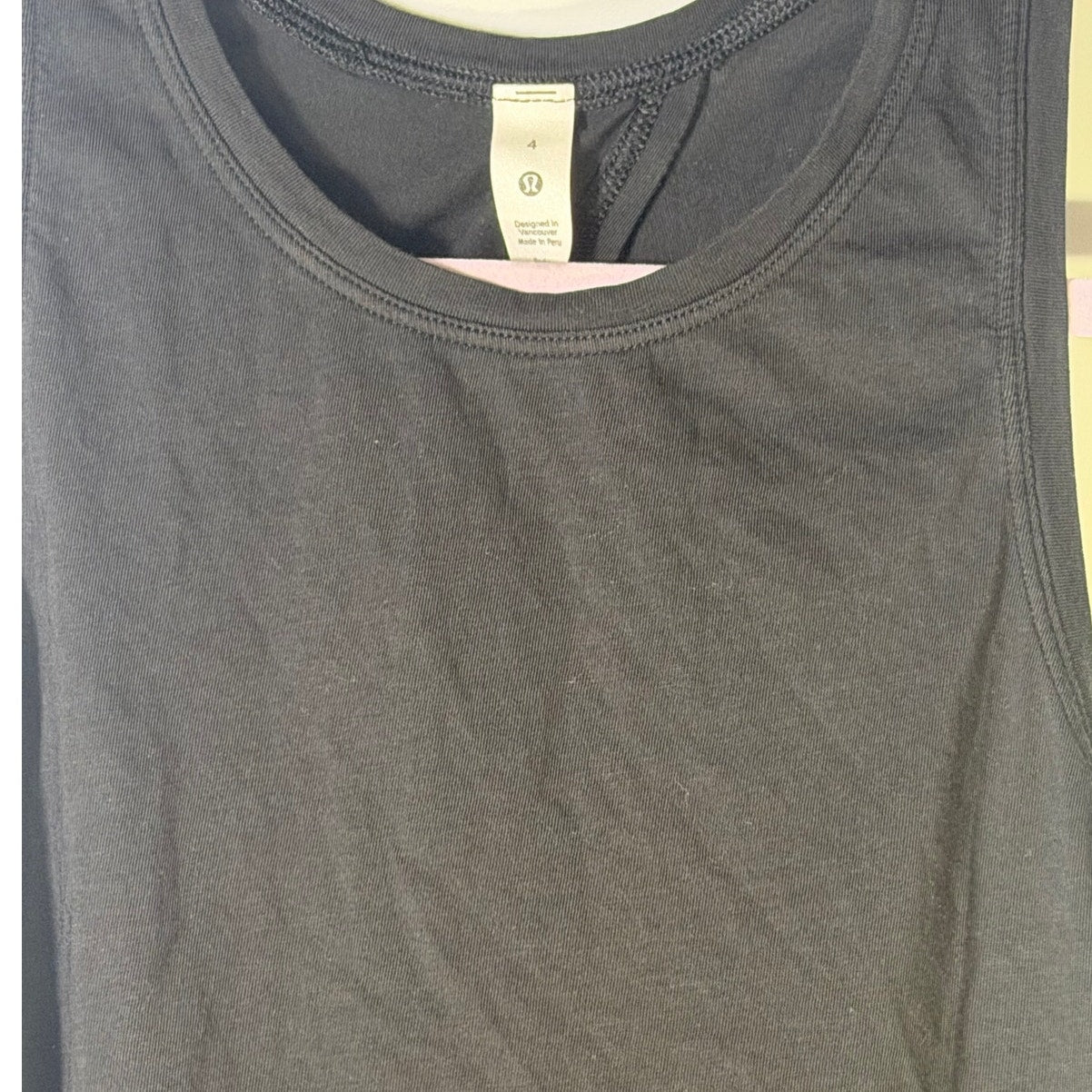 Black Lululemon women's high-neck open-back athletic tank top, size 4, with a sleek design and breathable fabric.