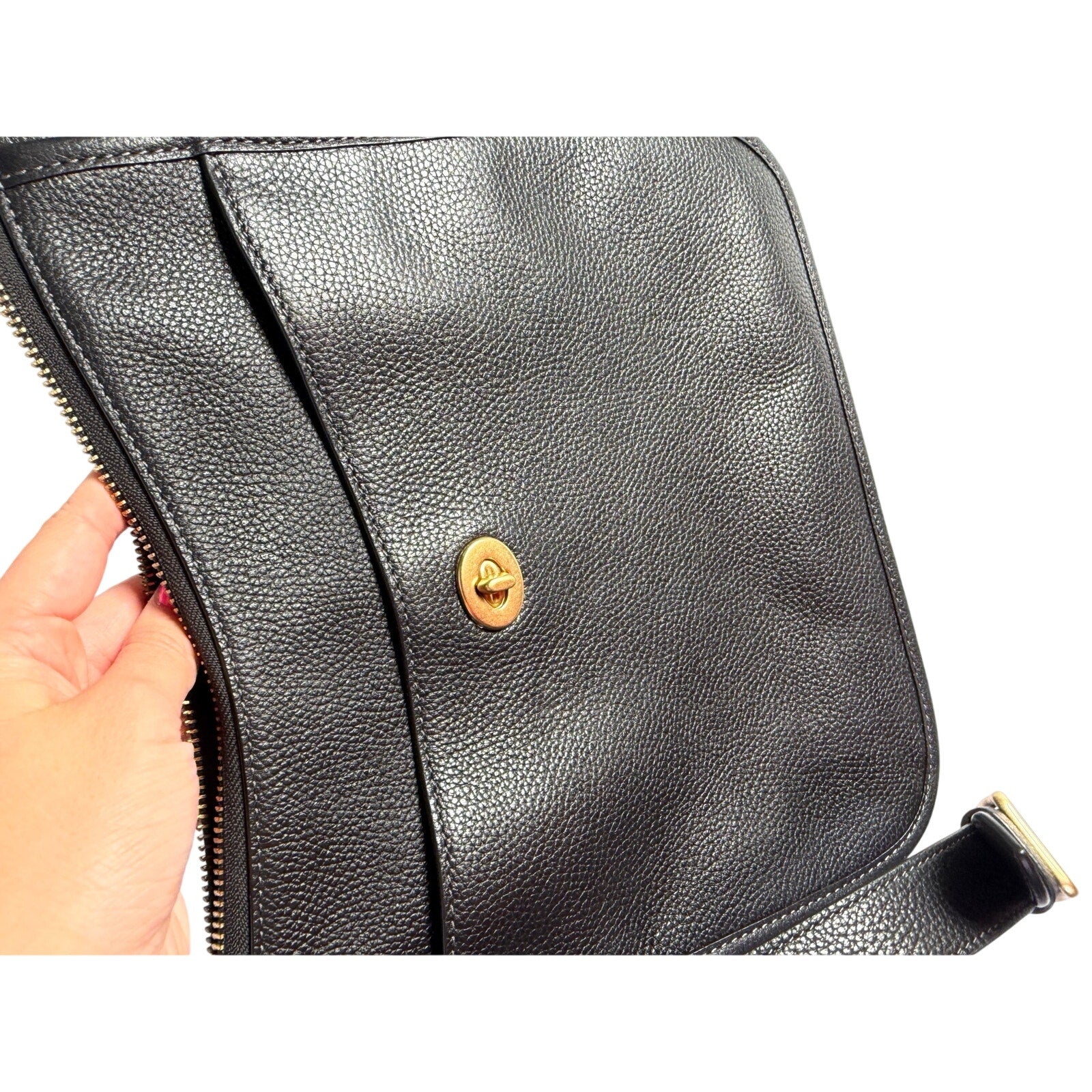 Coach women's black pebbled leather crossbody handbag with gold-tone hardware, stylish shoulder bag for everyday use.