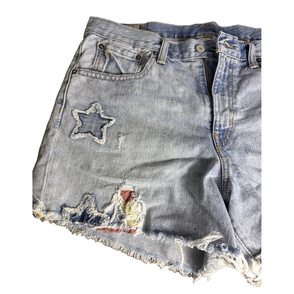 Light wash Polo Ralph Lauren women's distressed star patch denim cutoff shorts, size 29, with frayed edges and star patches.