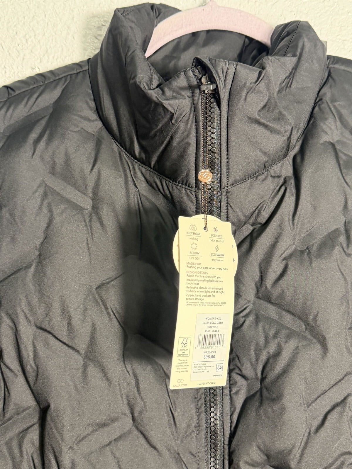 Women's CALIA Cold Dash Run Vest in pure black, XXL size, displayed on a hanger with a front view showing the lightweight design.