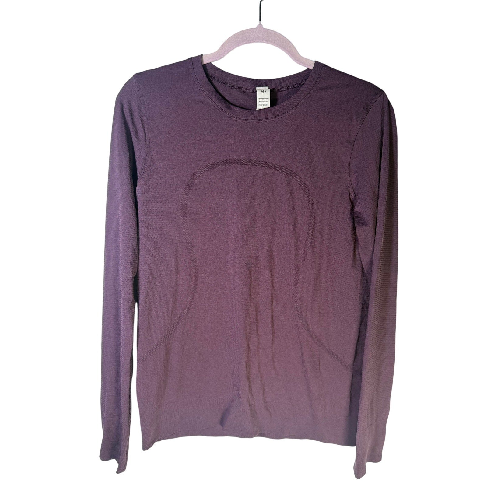 Lululemon women’s Swiftly Tech long-sleeve athletic shirt in purple, size 6, made of lightweight, breathable fabric.