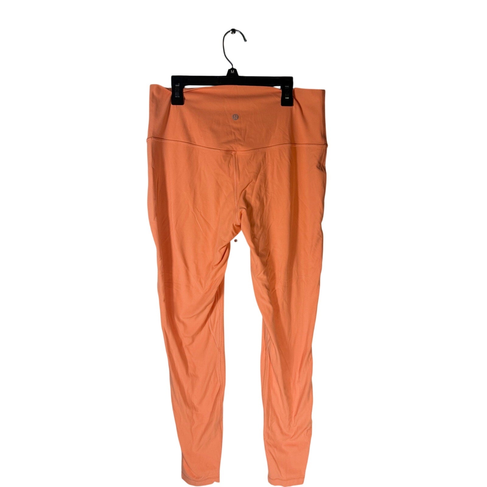 Lululemon women's high-rise burnt orange leggings, size 12, featuring a fitted design and comfortable stretch fabric.
