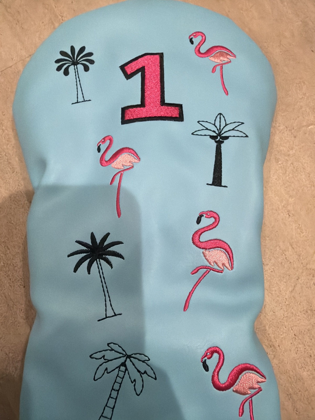 Light blue faux leather flamingo and palm tree golf driver headcover, unbranded, designed for protection and style during golf games.