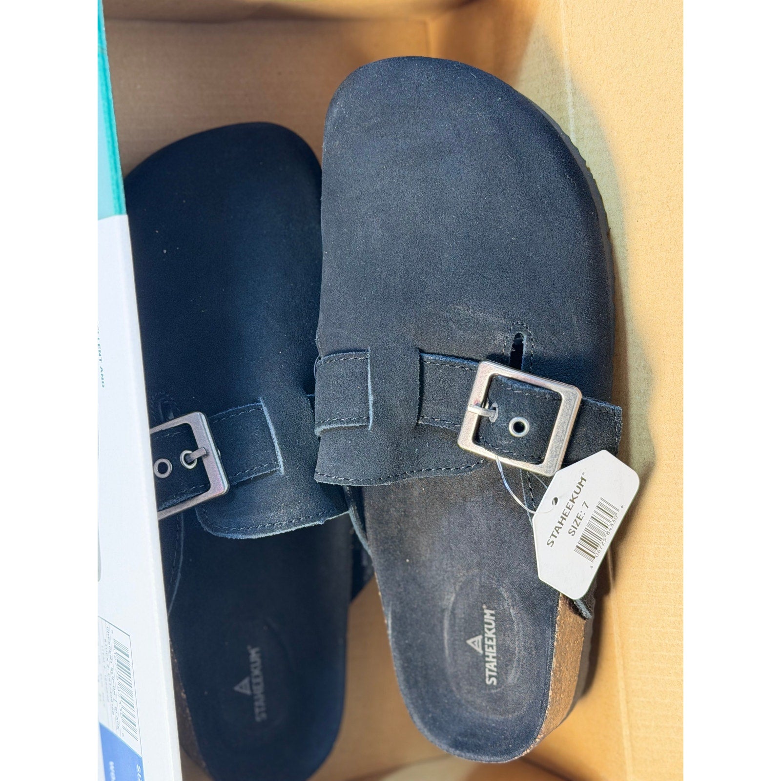 Black Staheekum women's buckle slip-on clogs, size 7, flat shoes with a stylish buckle detail, new with tags.